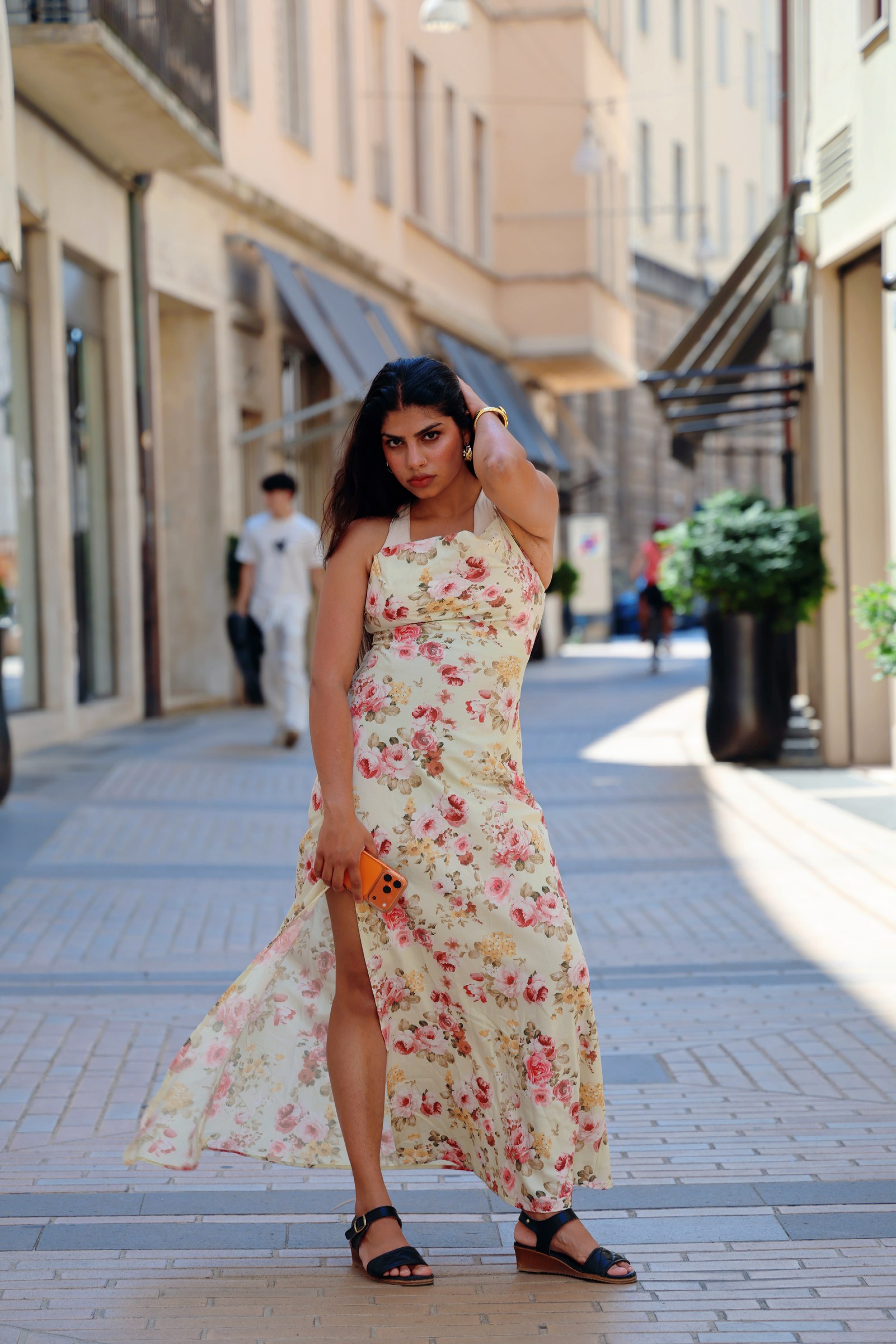 Vandana in a full-length floral dress on an Italian street